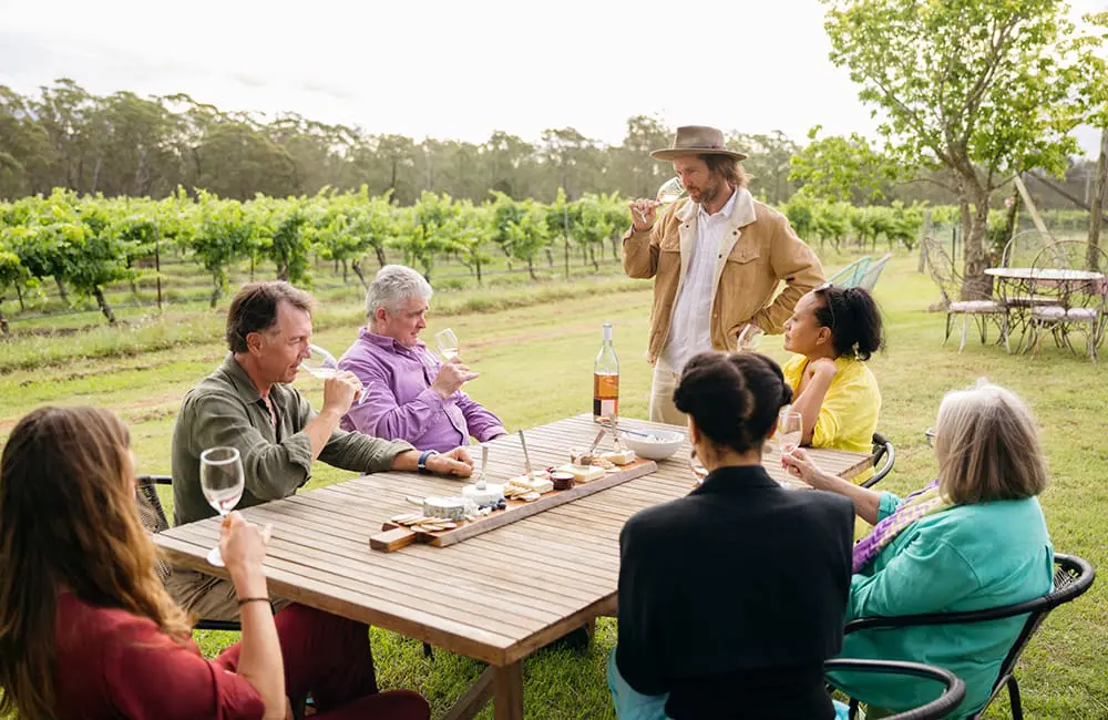 Group of people in vineyard in Australia for wine tasting experience. Image: JohnnyGreig/iStock