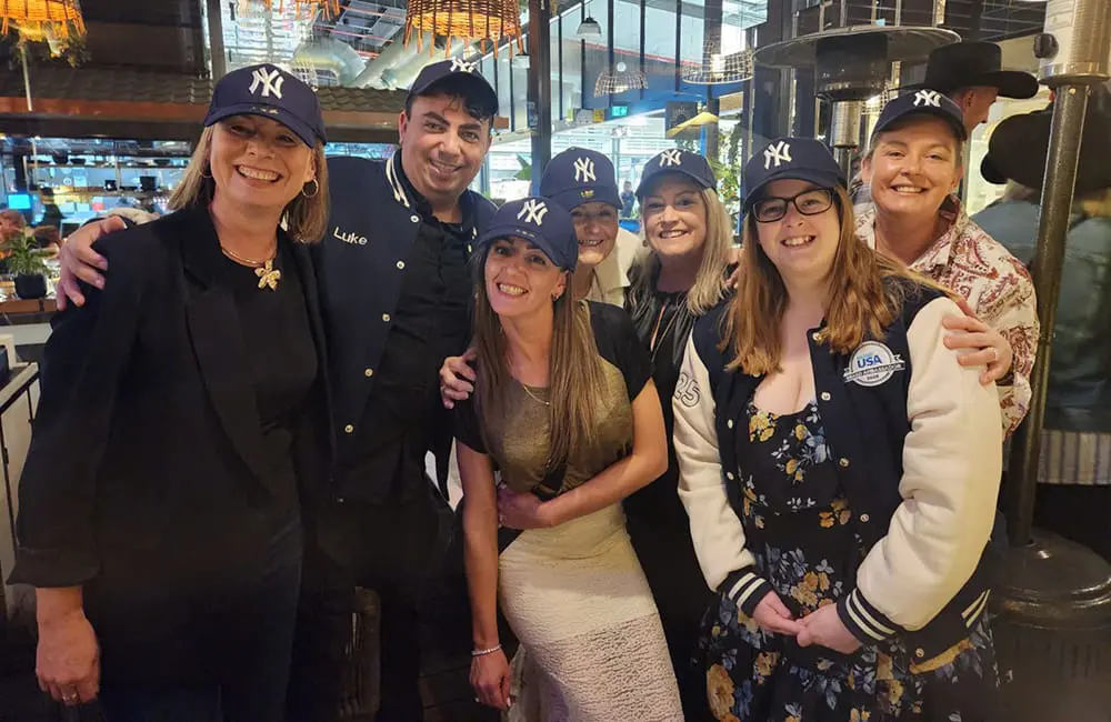 Brand USA Ambassador 2025 group in NY caps.