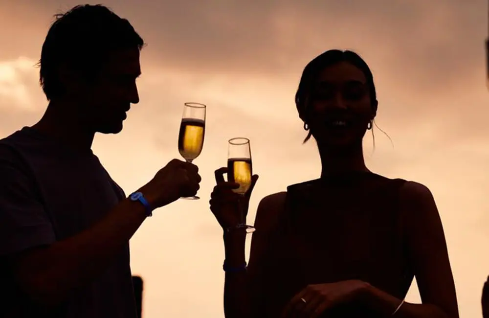 Couple with champagne glasses for Club Med Excusive Collection concept