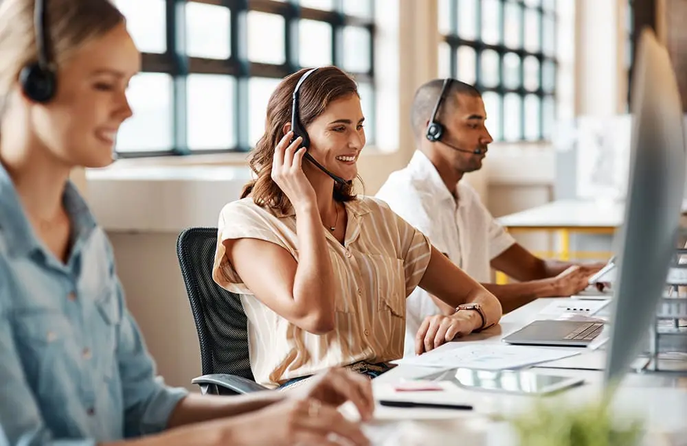 Airline customer service team with phone headsets at desk. Image: kupicoo/iStock