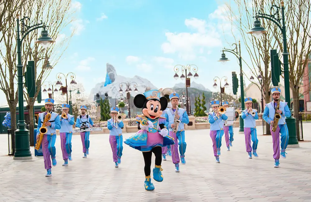 Minnie Mouse leads the Disney Marching Band on Adventure Way in Disney Adventure World at Disneyland Paris.