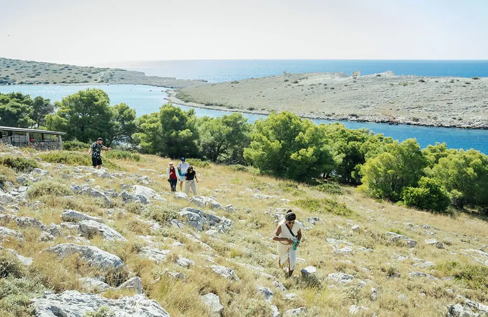Group of people walking the rocky hills of Kornati National Park in Dalmatia, Croatia. Image: Intrepid Travel