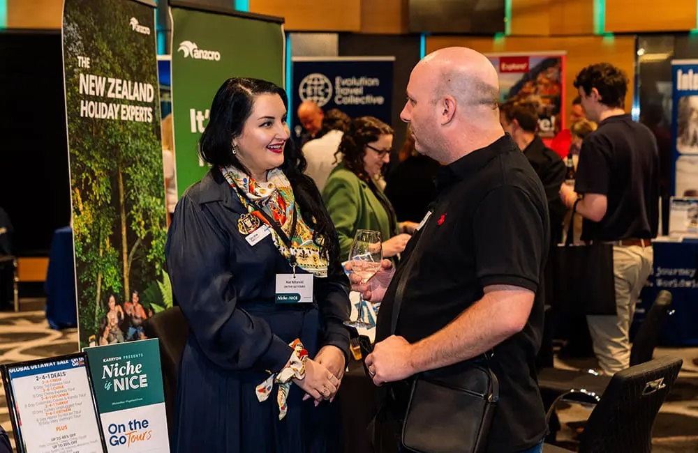 Travel advisor talking to On the Go Tours exhibitor at Niche is Nice 2025 in Brisbane 