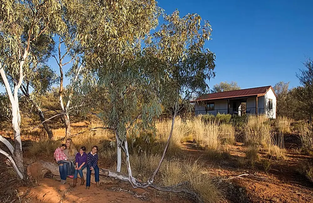 Family outside cottage at Ooraminna Station Homestead in the NT.