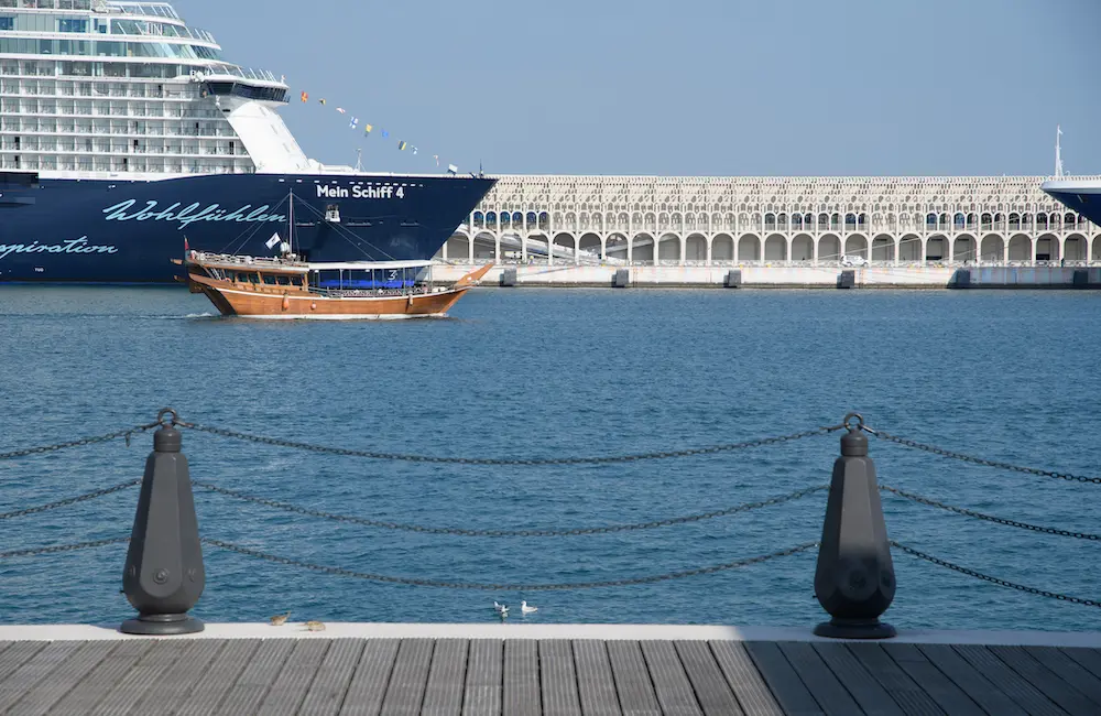 Doha, Qatar - January 4, 2025: A traditional dhow boat takes tourists on a cruise across the Arabian Gulf, with a cruise ship and the modern architecture of the cruise terminal in the background.
cruise ship
