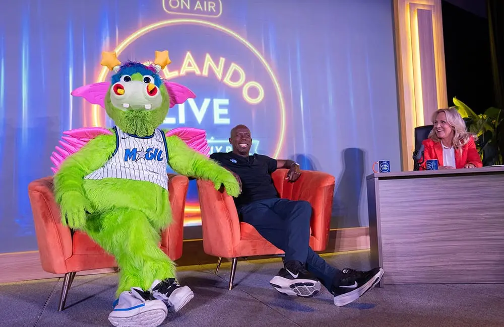 IPW 2026 closes in Fort Lauderdale: Connecting 5K attendees and US suppliers in travel 7 Orlando Magic's Stuff the Magic Dragon, retired basketball player Bo Outlaw and Visit Orlando President & CEO Casandra Matej at the Visit Orlando press conference at IPW 2026.