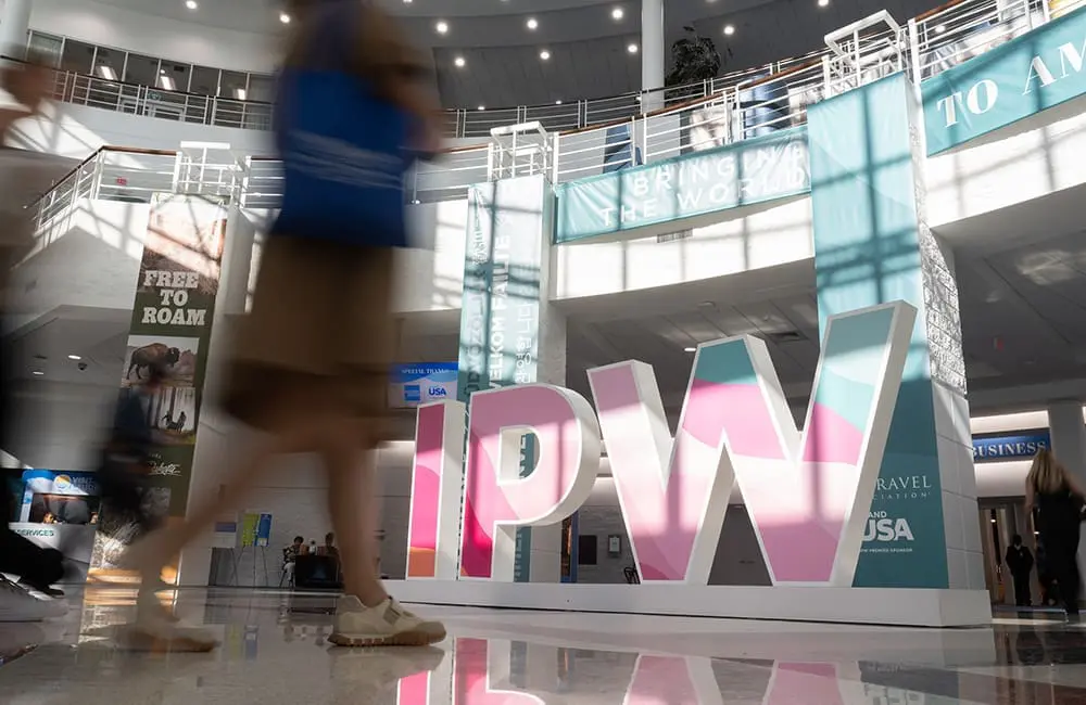 IPW 2026 closes in Fort Lauderdale: Connecting 5K attendees and US suppliers in travel 1 IPW 2026 sign with blurred people walking