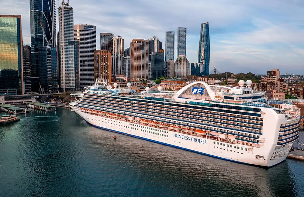 Crown Princess in Sydney with cityscape.