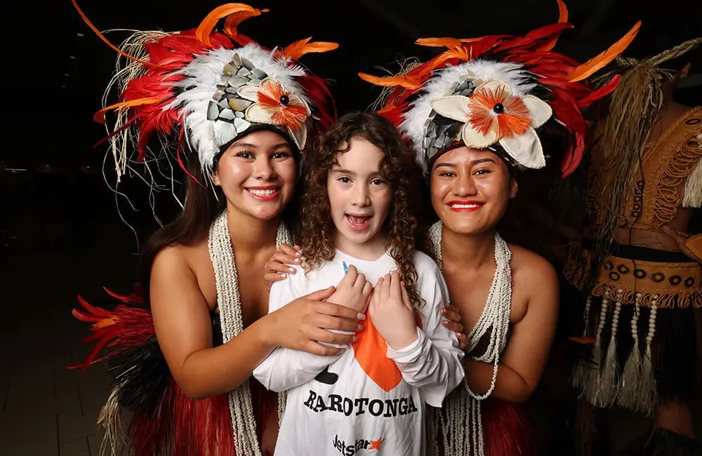 One of the first Jetstar Brisbane-Rarotonga flight passengers at BNE with Cook Islands dancers.