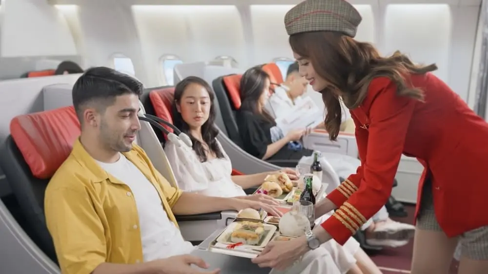 Vietjet flight attendant serving passenger onboard