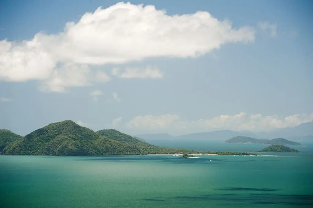 Accomm returns to iconic Queensland island where Elton John, UK royalty, stayed 2 View of beautiful nature of Dunk Island in sunny day with bright white cloud over sea and forest covered hills - Queensland, Australia