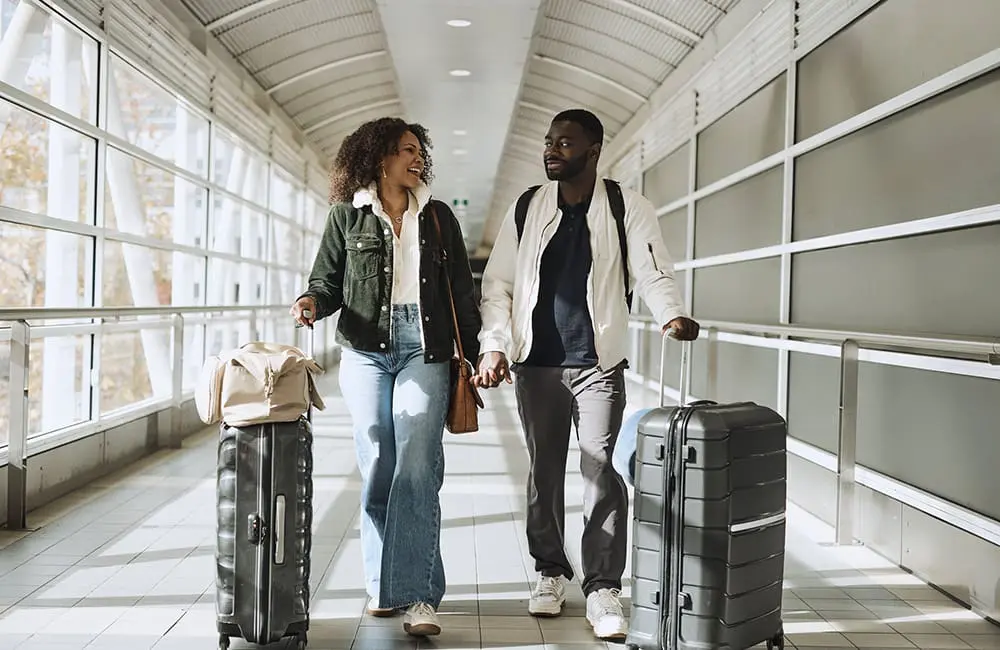Couple with suitcases at Melbourne Airport. Image: Melbourne Airport
