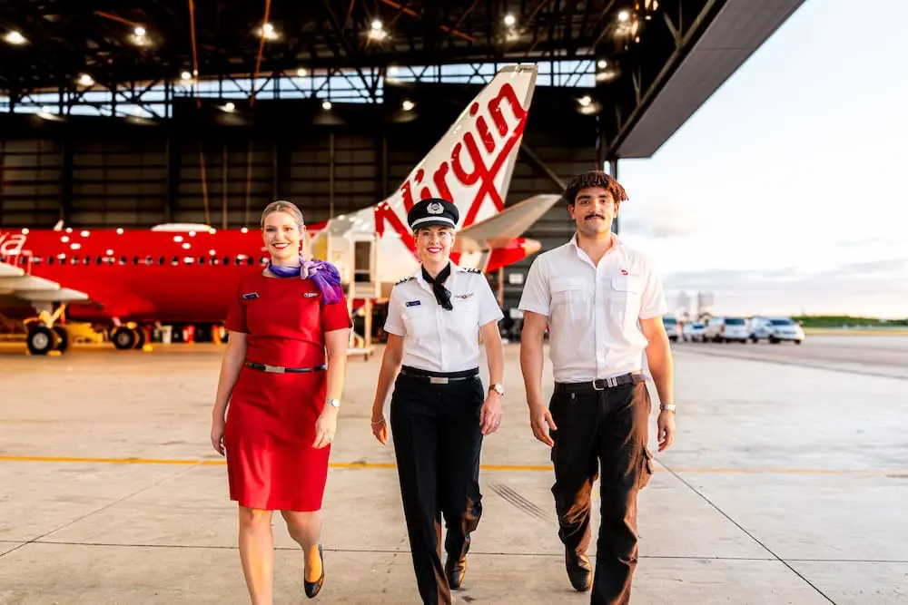Virgin Australia's Angela D'Andrea, Amy Dunn, Matt Bonser in front of Lake Centenary