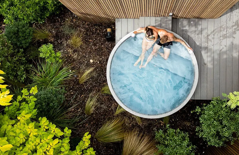 Drone shot of couple in hot pool at Bathe by Aluume, billed as Queenstown's first centrally located hot pool experience.