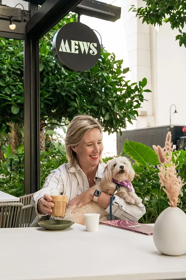 Woman at Mews cafe outside Crystalbrook Vincent hotel in Brisbane