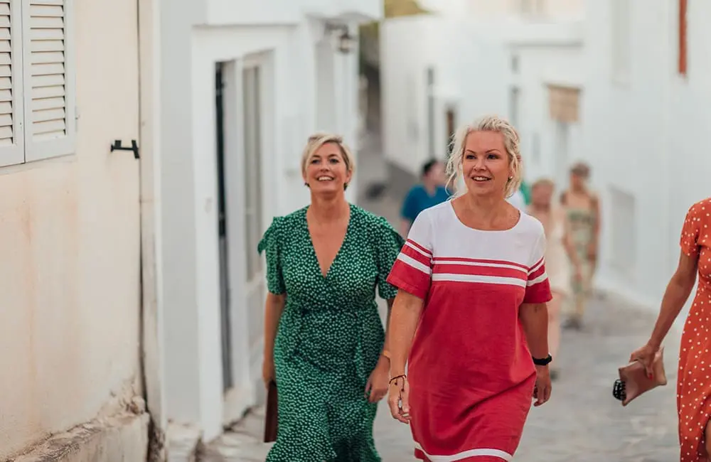 Australia's favourite escape leads global list of best summer girls' trips 3 Women walking in village in Greece for girls' trip concept. Image: SolStock/iStock