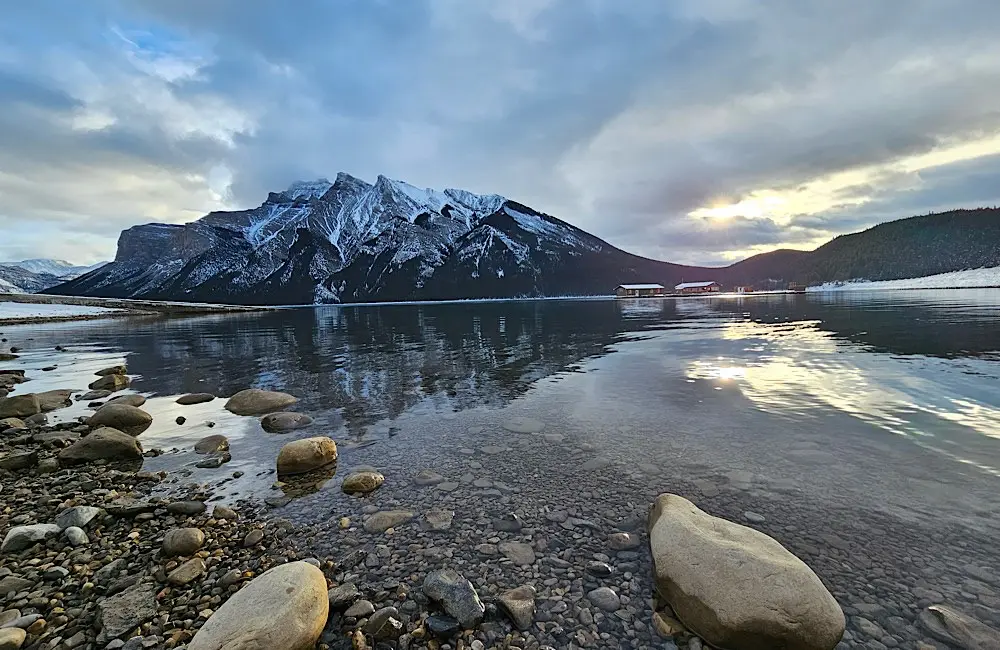 A still mountain lake moment captures the kind of scenery that makes Canada feel impossible to tick off in one trip. Image: Teagan Gunter