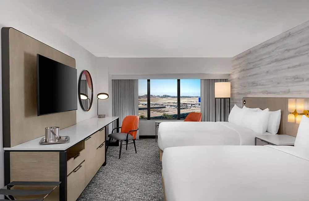Fresh from LA: The hottest hotels, dining spots, events and attractions for 2026 7 Render of Two Queen Bed guestroom with runway views at Hilton LAX. Image: Hilton – Los Angeles Tourism updates