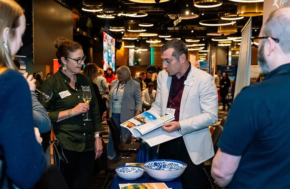 Albatross Tours' Harry Sargant chats with travel advisors at Niche is Nice 2025 in Brisbane.