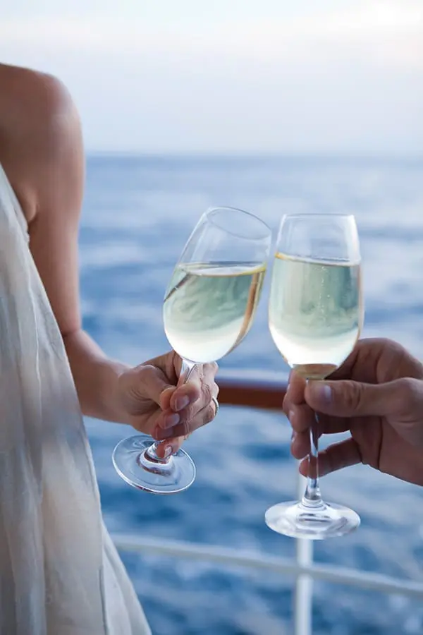 Regent 2027 Spotlight Voyage Collection features four wine-themed sailings –couple with Champagne on deck