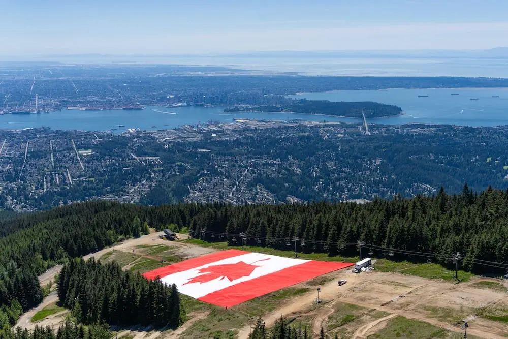 Record breaking Canadian Flag on bottom of The Cut at Grouse Mountain with city view_GMR Canada Flag 2026