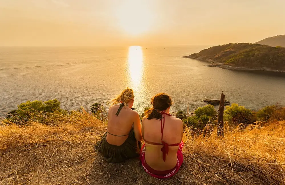 Australia's favourite escape leads global list of best summer girls' trips 2 Two women with back to camera at Phuket clifftop looking at sea. Image: Bubbers13/iStock