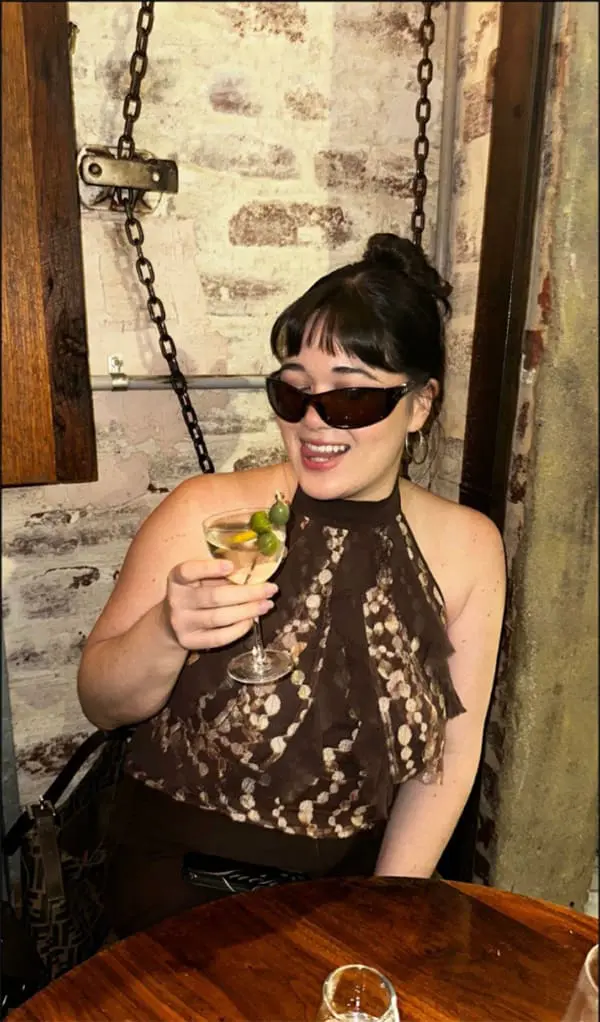 Female with cocktail in bar – Urban List 26 travel report