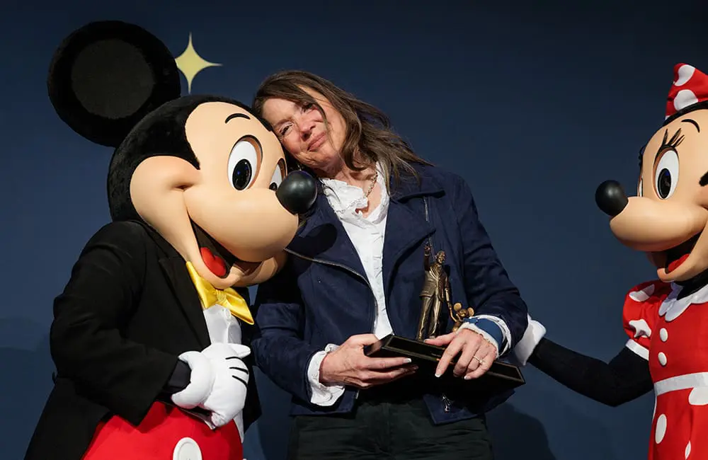 Visit California President and CEO Caroline Beteta with Mickey Mouse and Minnie Mouse at her retirement dinner  at the Grand Californian. Image: Max Whittaker