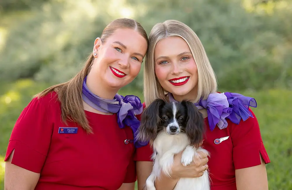 Virgin Australia crew members with small dog for Pets in Cabin services start in Adelaide