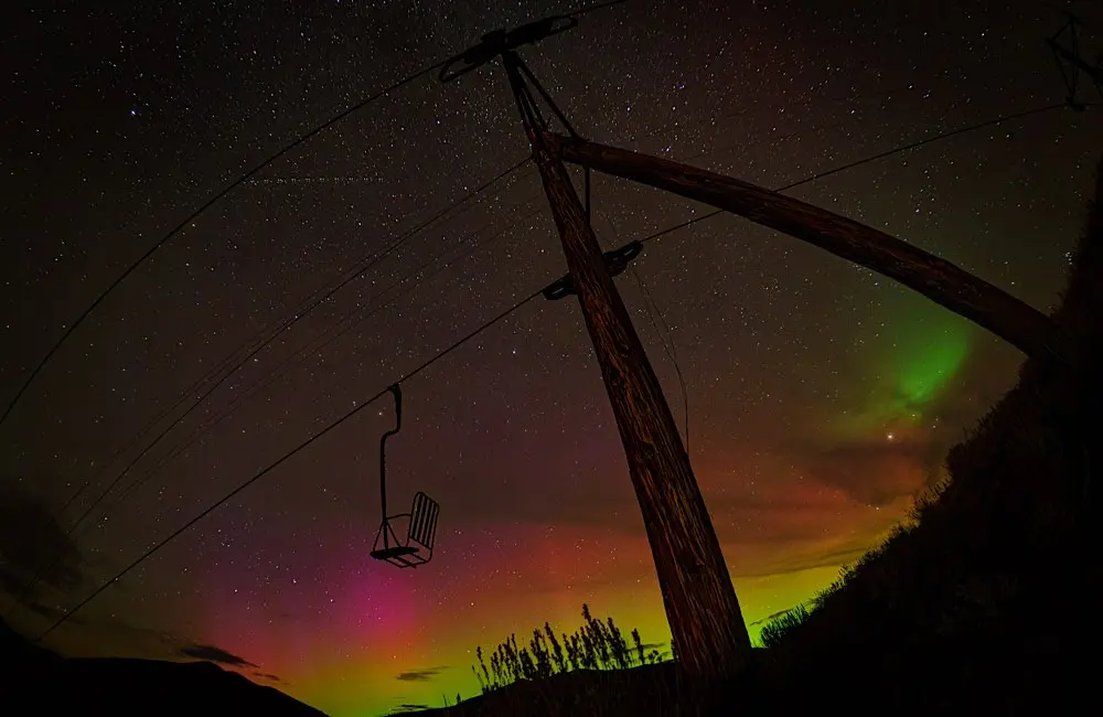 The northern lights illuminate the sky above a chairlift at Sun Valley, Idaho. Credit: James Conrad / Sun Valley Resort
