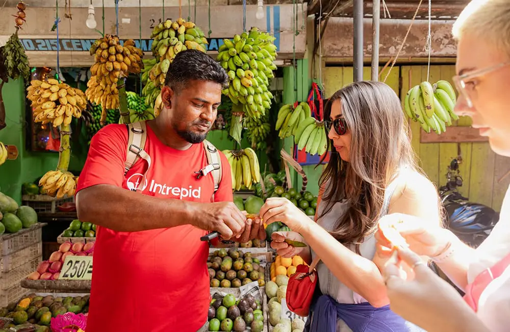 Intrepid Travel Market Wander and Tasting with leader Dodan and travellers Maz and Laura in Kandy, Sri Lanka. The 30 Collective
