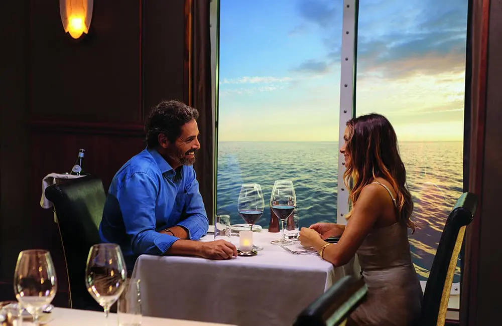 Couple at Le Bistro with ocean view on NCL cruise ship. Image: NCL