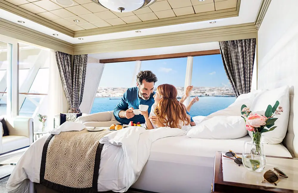 Couple in bedroom on Norwegian Star. Image: NCL