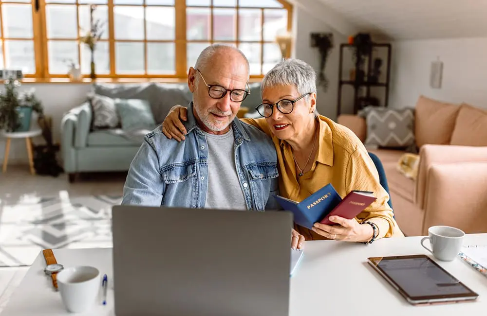 Senior couple booking travel online at home - AI-generated holiday listing. Image: hobo_018/iStock