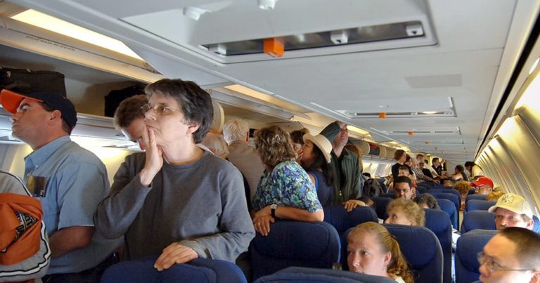 People who stand up as soon as plane lands certain they will get off faster