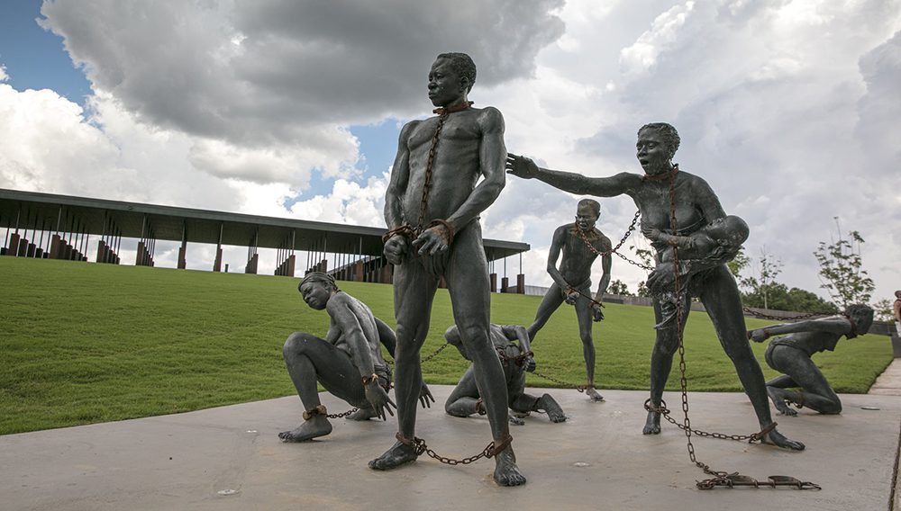 A statue depicts a slave family in chains at the Memorial for Peace and Justice in Montgomery, Alabama. Image credit: Chris Granger