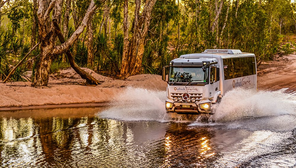 Onboard Outback Spirit's 5-star 4WD coach, crossing Drysdale River, Kimberley
