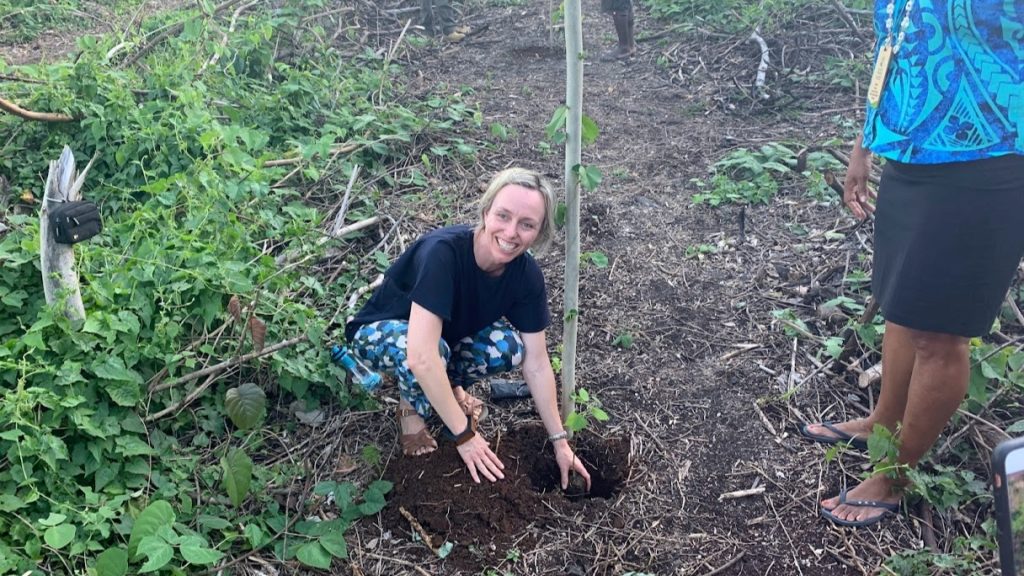 Planting a tree at carbon offset project in Espiritu Santo Vanuatu