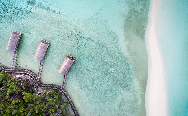 Bawah Reserve aerial overwater suites over lagoon