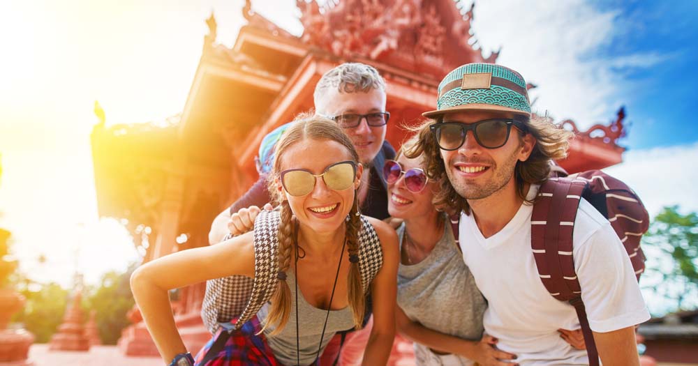 Tourists in Thailand in front of temple.