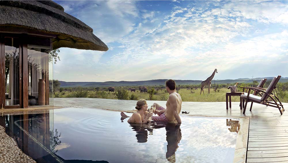 South African Tourism Couple relaxing in a pool in Madikwe