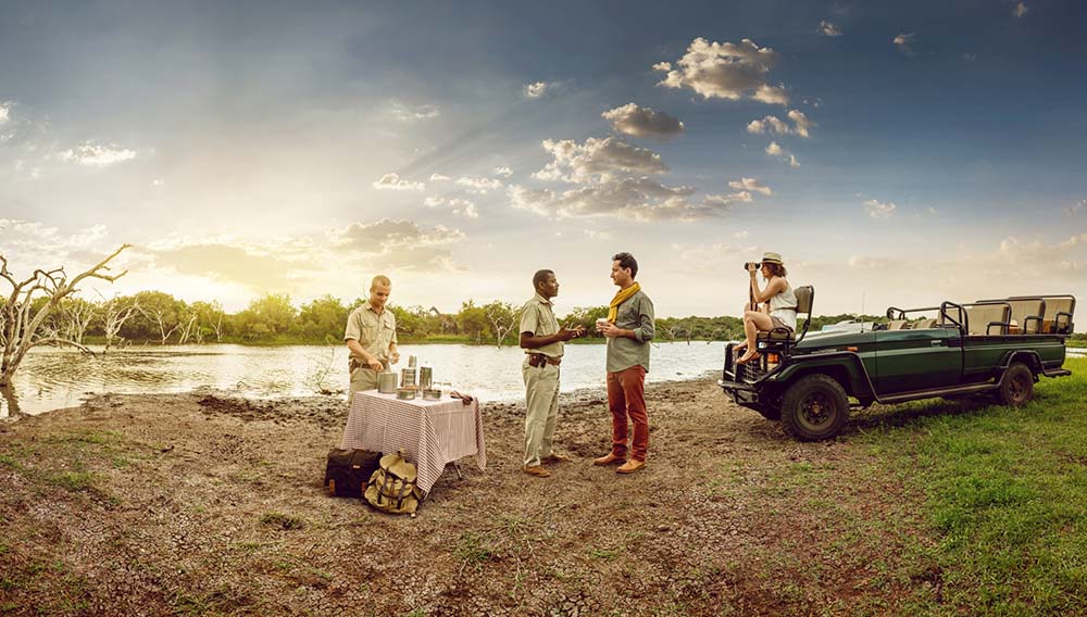 South African Tourism People enjoying refreshments at the side of a lake in Phinda