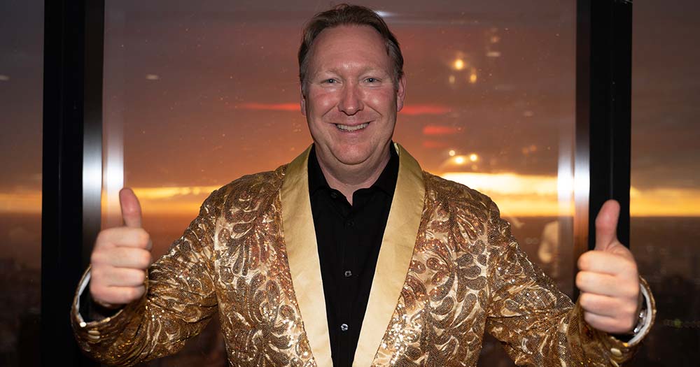 Man in sparkling gold jacket.