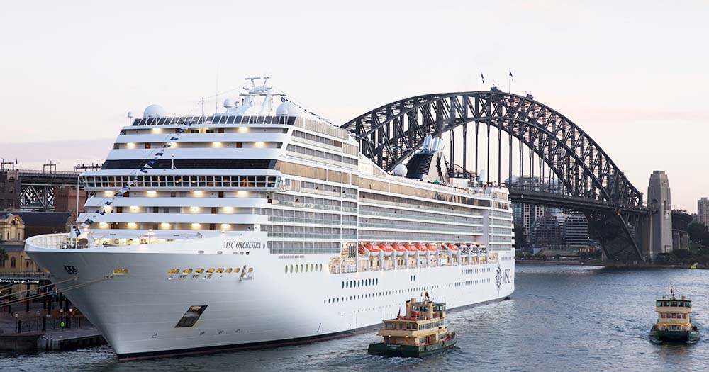 MSC Orchestra cruise ship docked in Sydney with Harbour Bridge in background.
