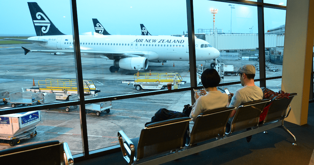 Passengers wait to board a flight at Auckland Airport before the cyclone.