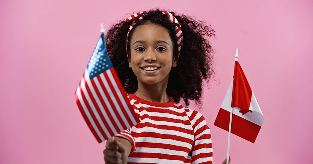 America USA and Canada flags young girl