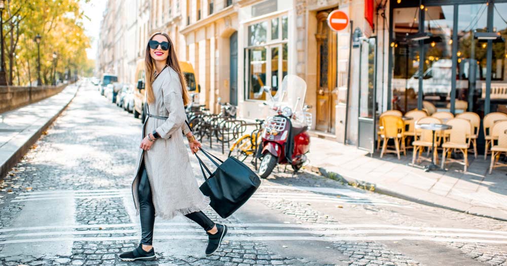 Stylish woman crossing street in Paris.