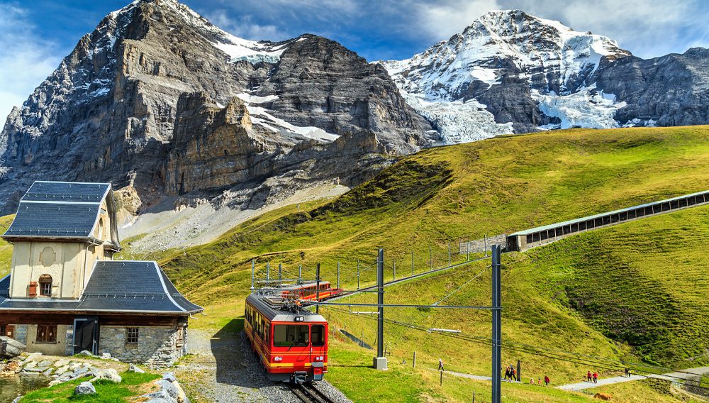 Famous electric red tourist train coming down from the Jungfraujoch stationtop of Europe in Kleine