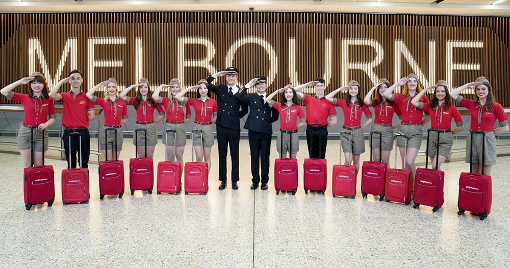 Vietjet airline crew with Melbourne sign in Melbourne Airport.