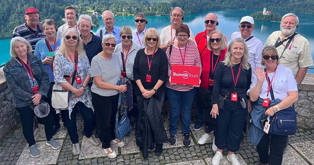 Tour group poses at lookout at Lake Bled, Slovenia.